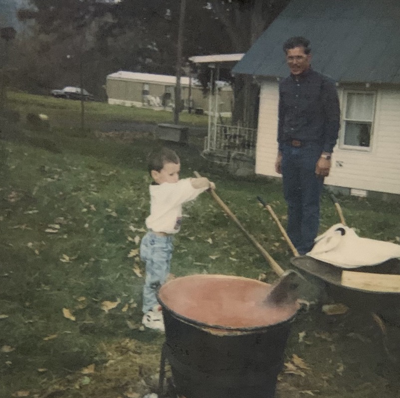 Family photo outdoors by a large kettle