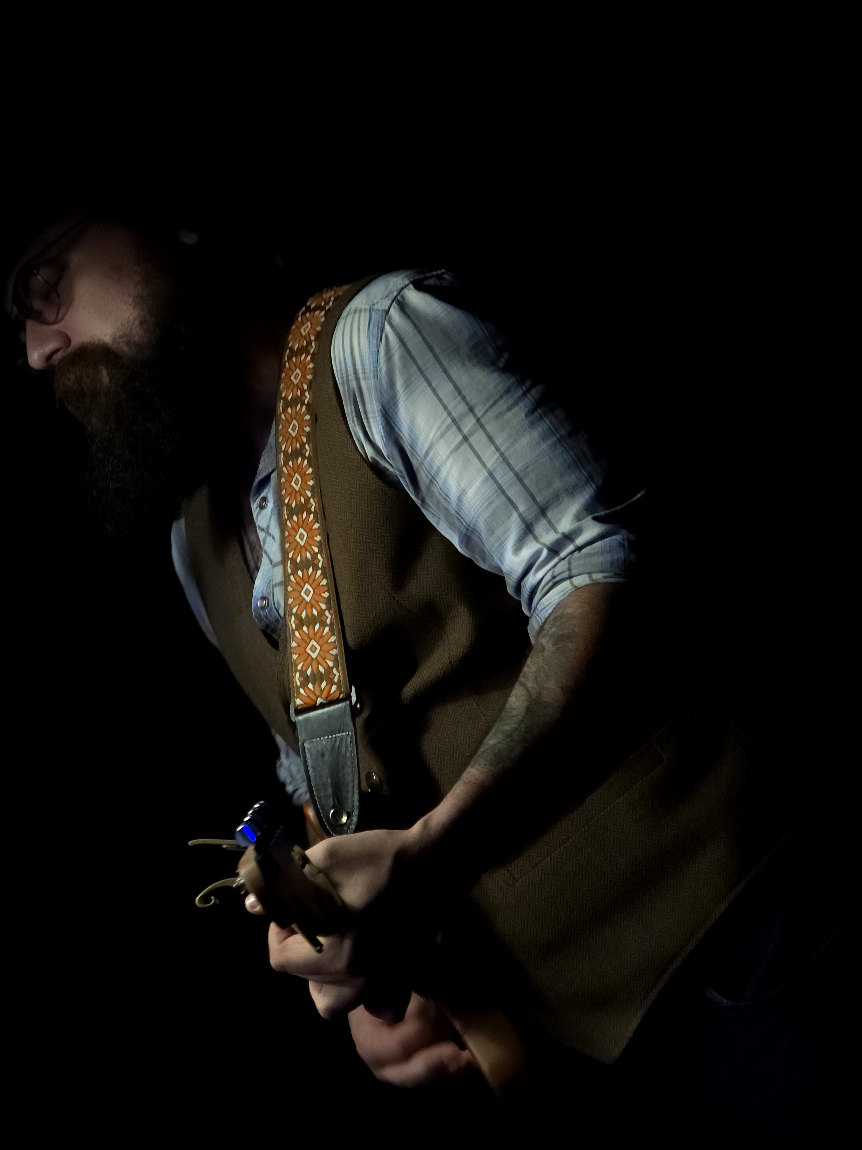 The Hobo Troubadour playing guitar in the dark